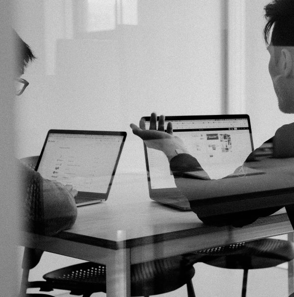 day in the life: 2 colleagues looking at their PC's